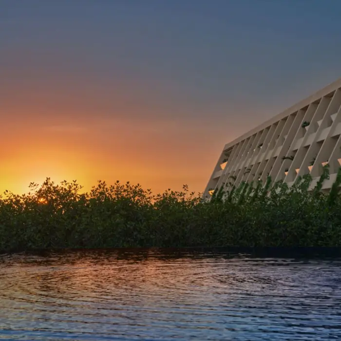 sunset over the main building at The Riviera Maya EDITION at Kanai