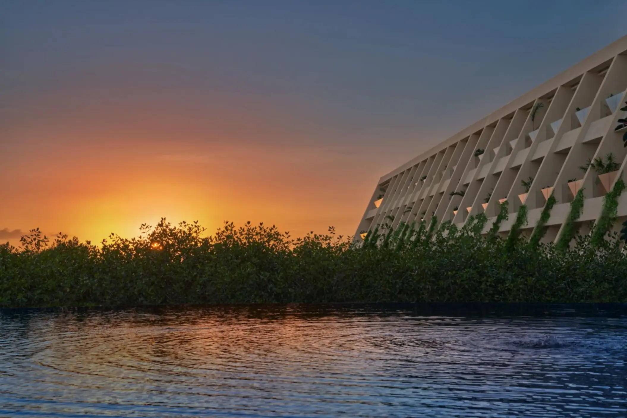 sunset over the main building at The Riviera Maya EDITION at Kanai