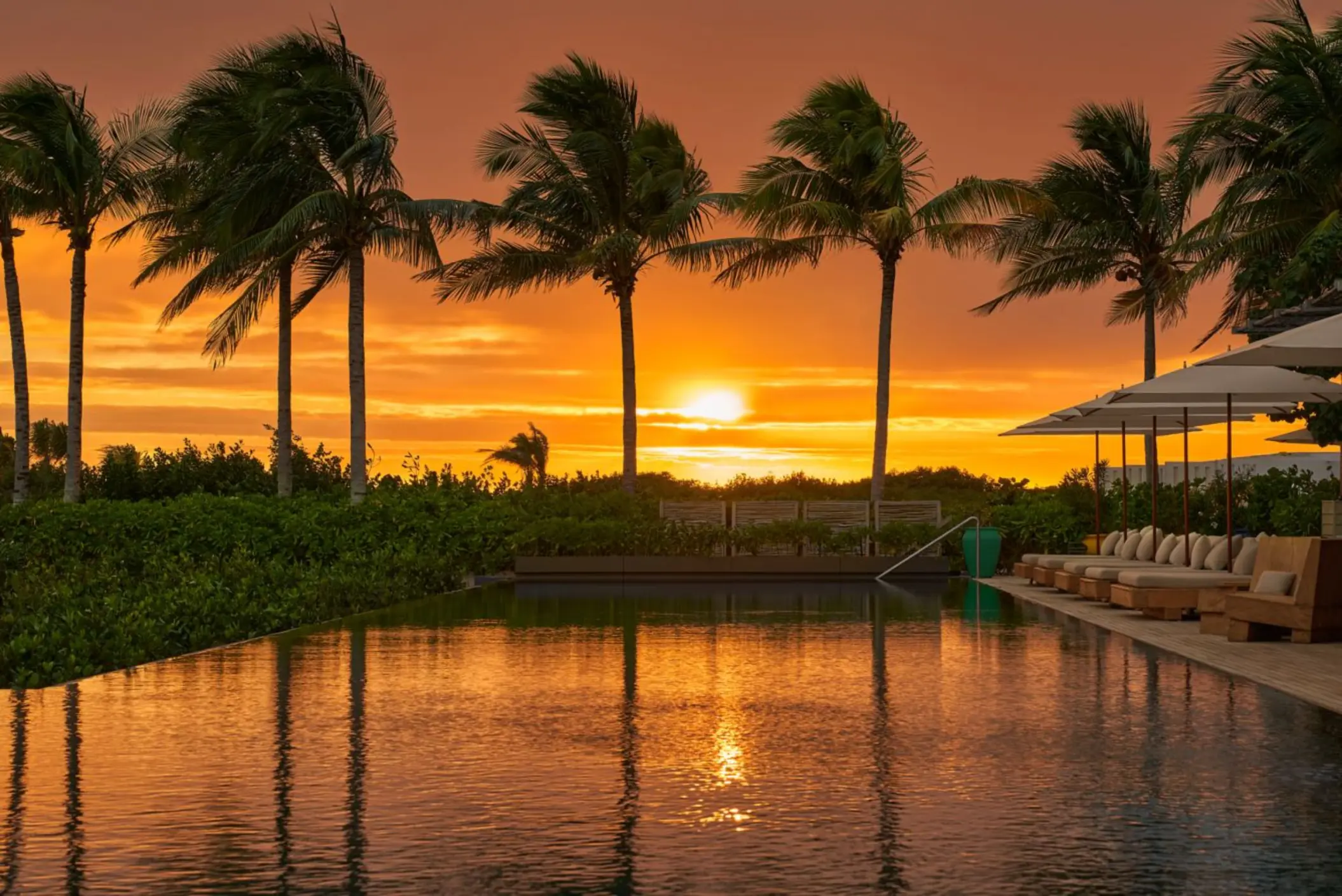 sunset over the pool at The Riviera Maya EDITION at Kanai