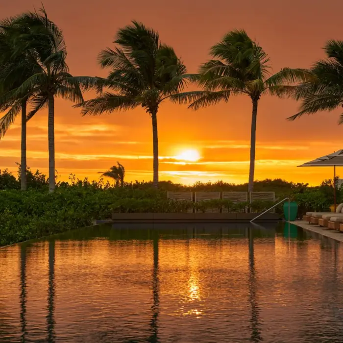 sunset over the pool at The Riviera Maya EDITION at Kanai
