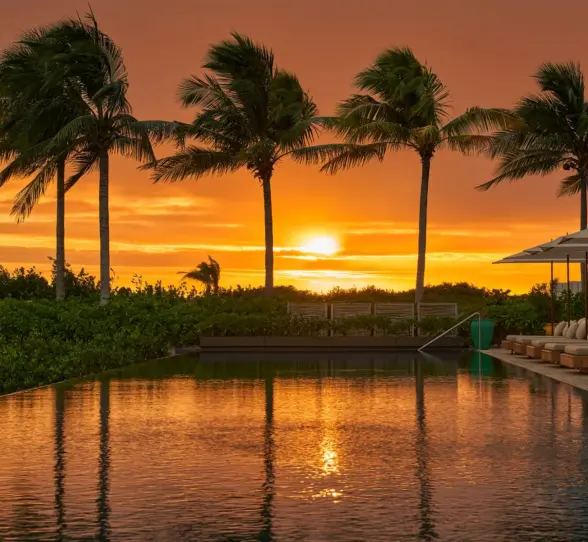 sunset over the pool at The Riviera Maya EDITION at Kanai