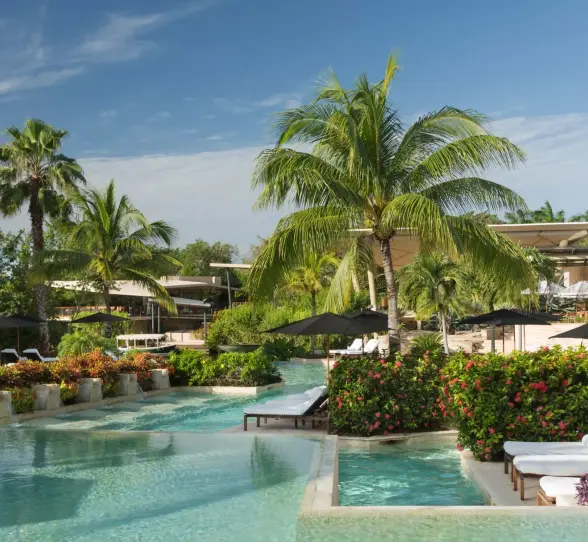 Casa del Lago outdoor pool with tropical greenery at Rosewood Mayakoba