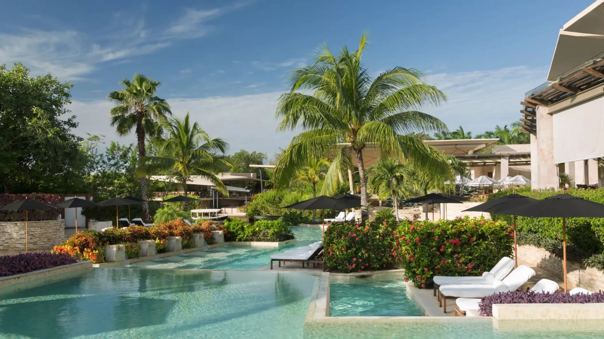 Casa del Lago outdoor pool with tropical greenery at Rosewood Mayakoba