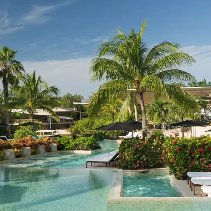 Casa del Lago outdoor pool with tropical greenery at Rosewood Mayakoba