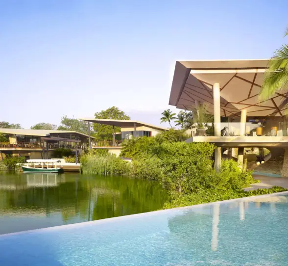 Lagoon and resort lobby view from bridge at Rosewood Mayakoba