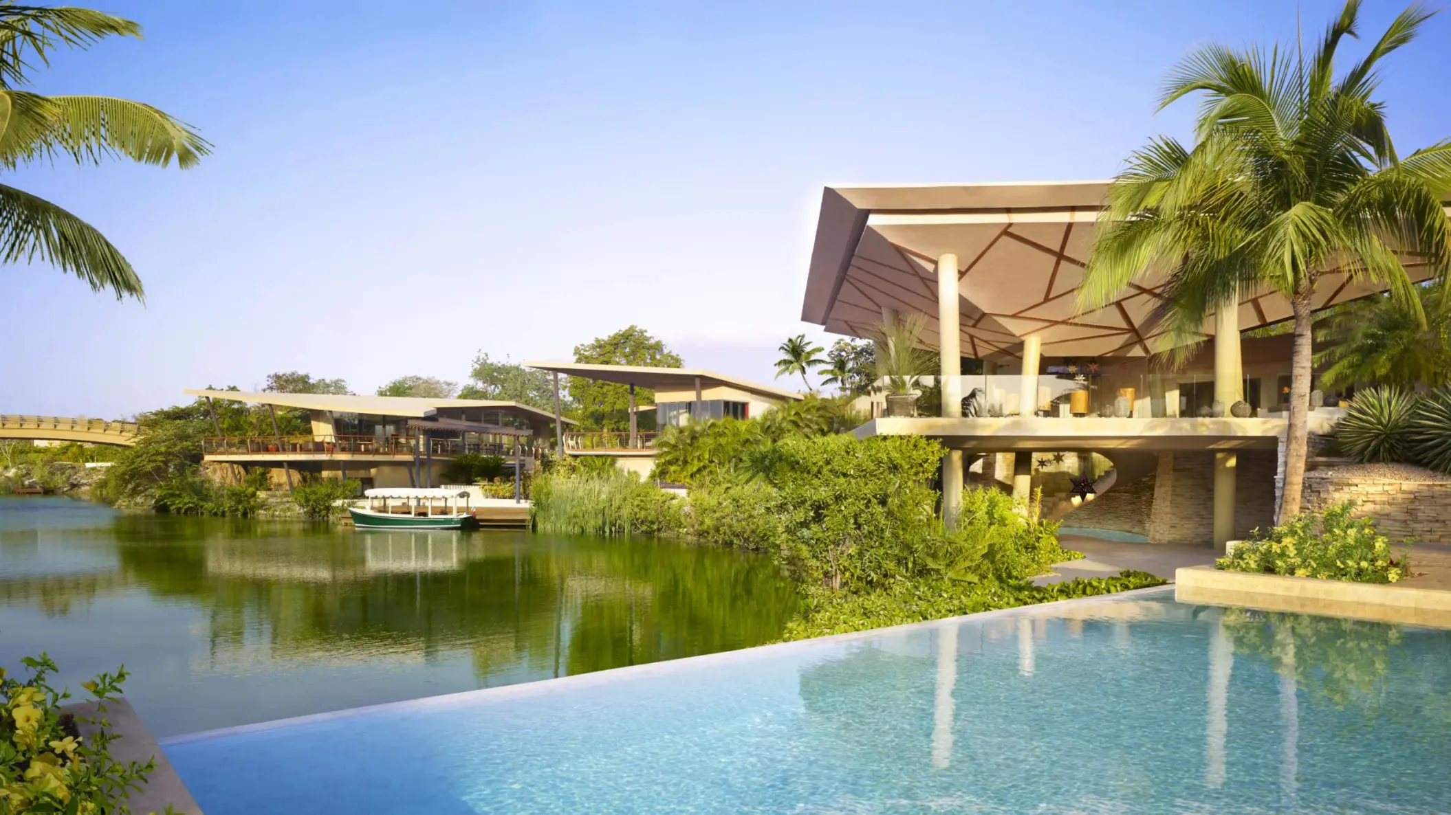 Lagoon and resort lobby view from bridge at Rosewood Mayakoba