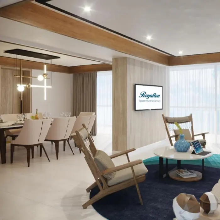 Spacious modern suite with dining area, living room, and large windows bringing in natural light.