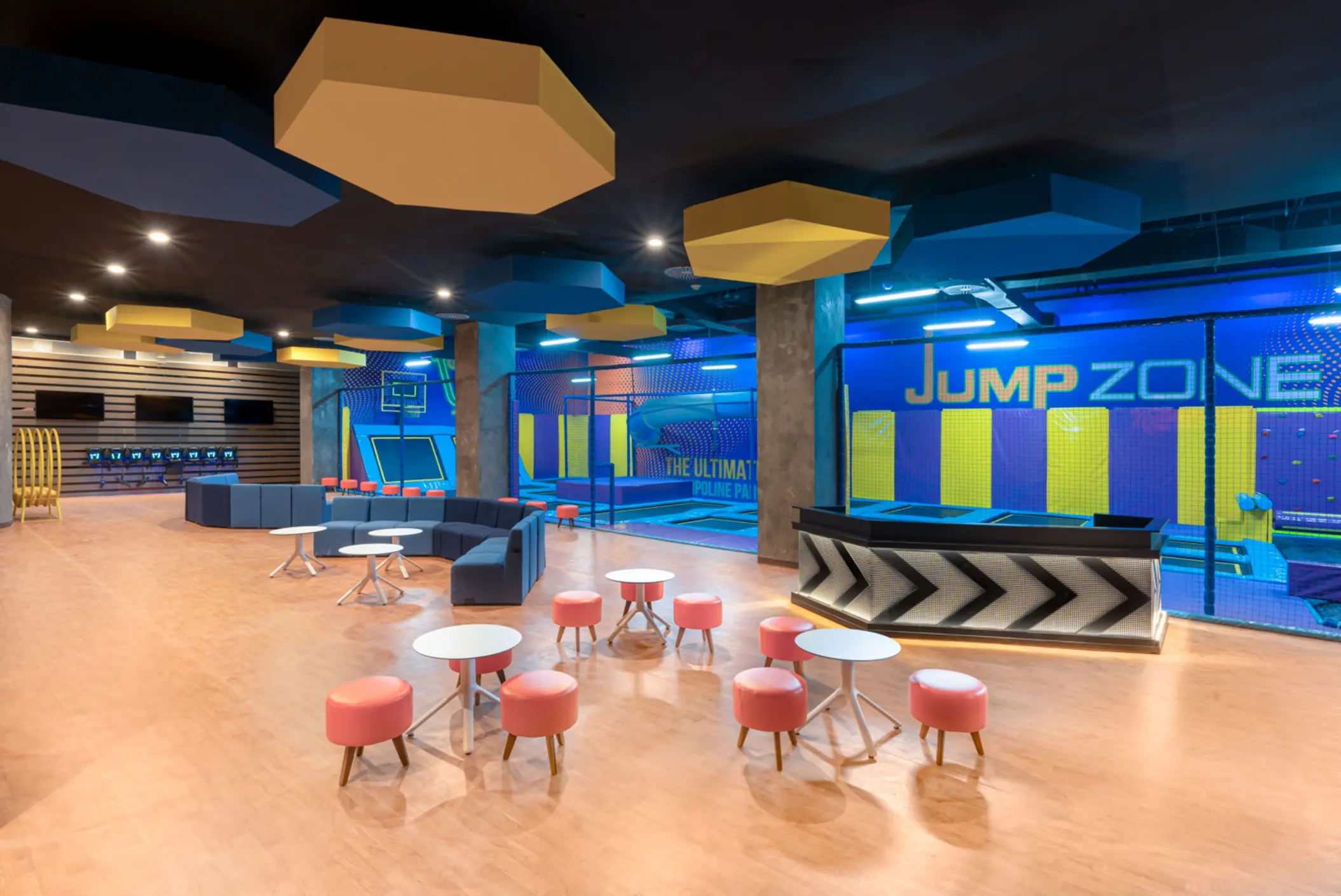 Indoor trampoline park with padded floors, jump zones, and bright decor for kids and teens to play safely.