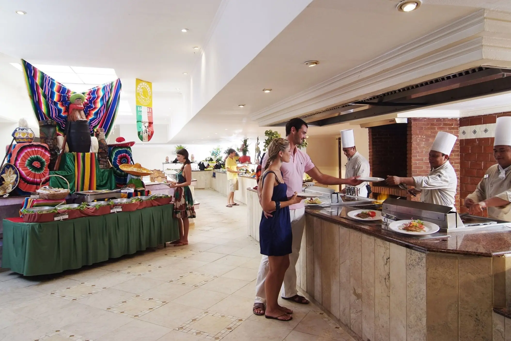 Guests are served food at a vibrant buffet line with decorative elements at Laguna restaurant.