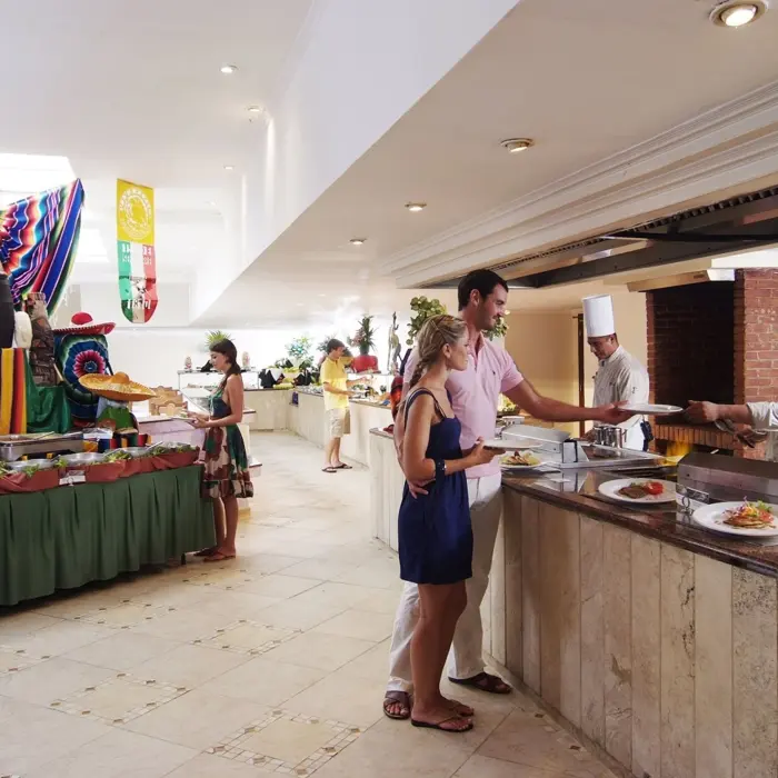 Guests are served food at a vibrant buffet line with decorative elements at Laguna restaurant.