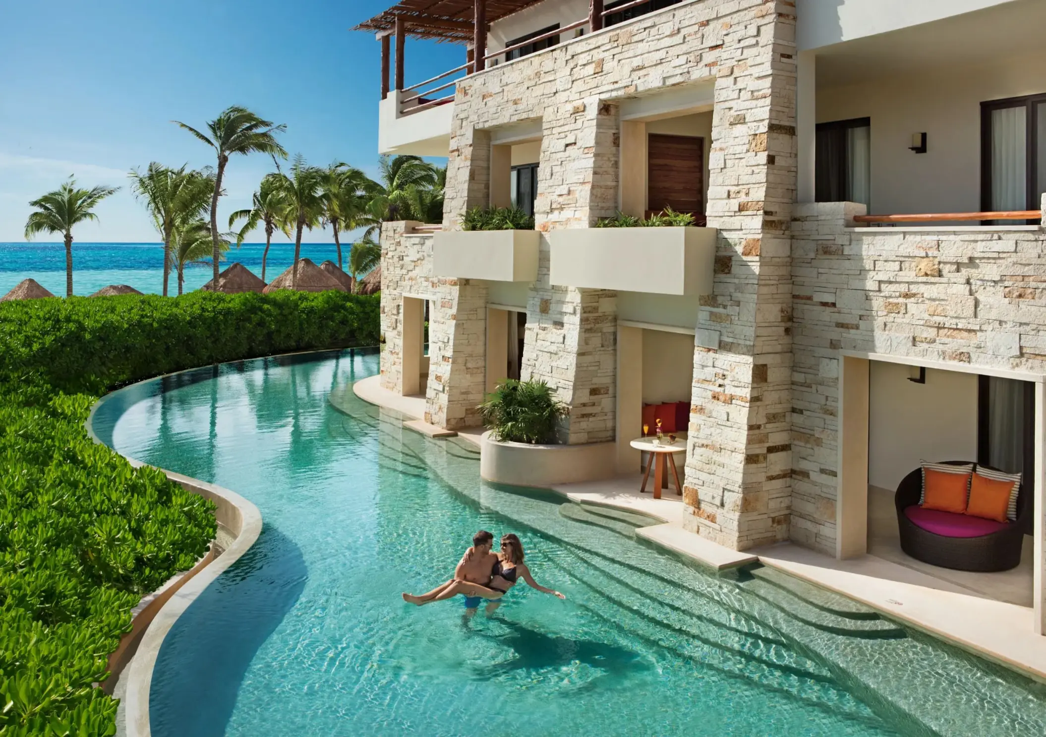 couple in the pool outside their swim out suite at Secrets Akumal Riviera Maya