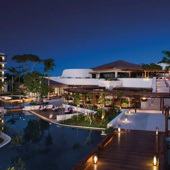 Secrets Akumal Riviera Maya grounds lit up in the evening