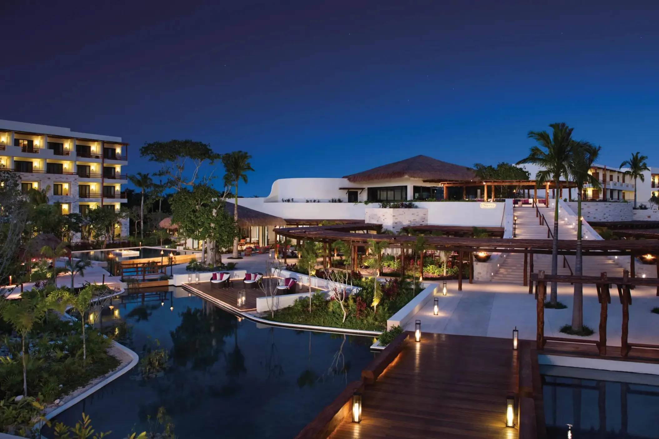 Secrets Akumal Riviera Maya grounds lit up in the evening