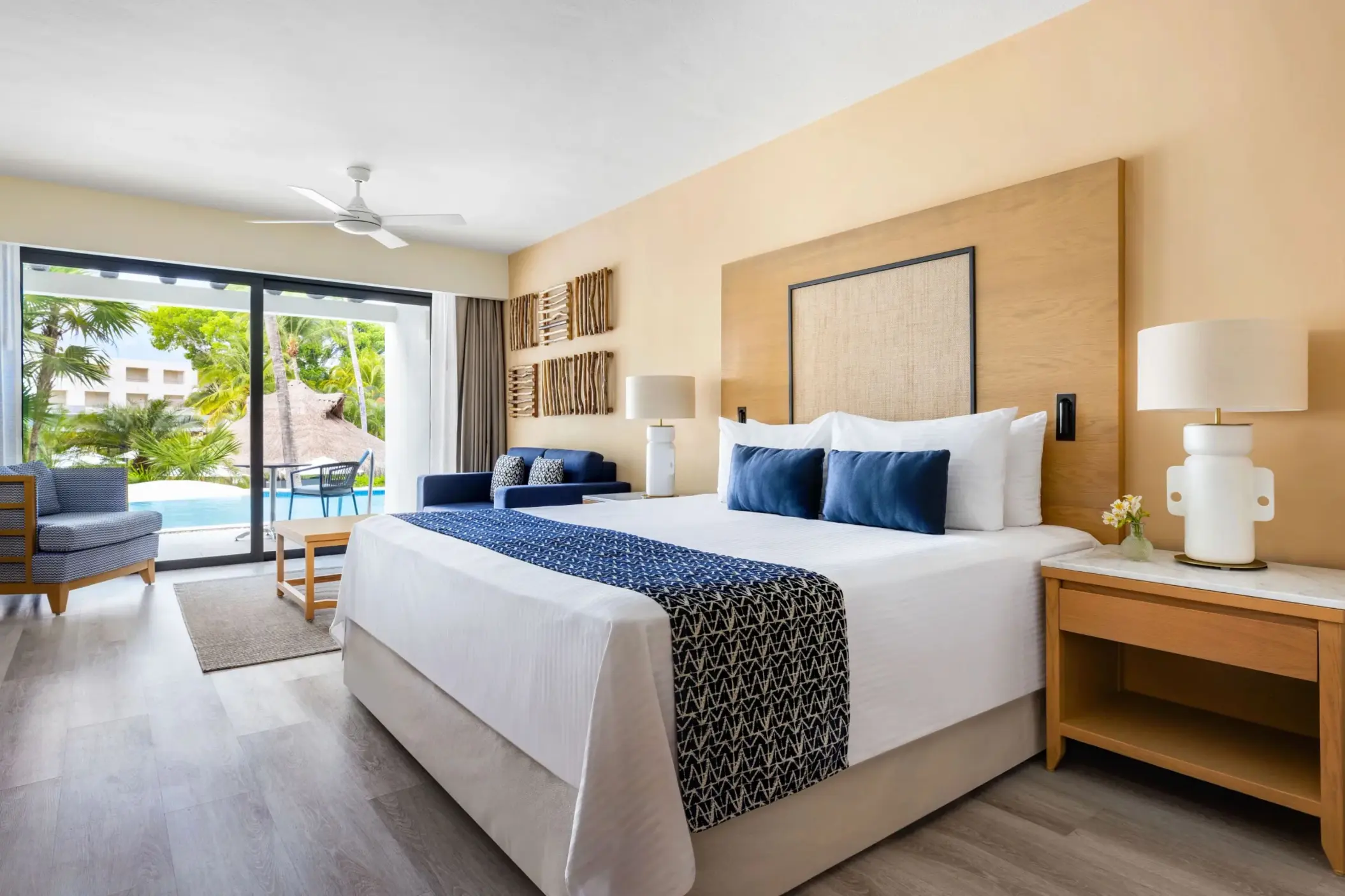 Swim-up junior suite with king bed, tropical decor, and direct pool access from private terrace.
