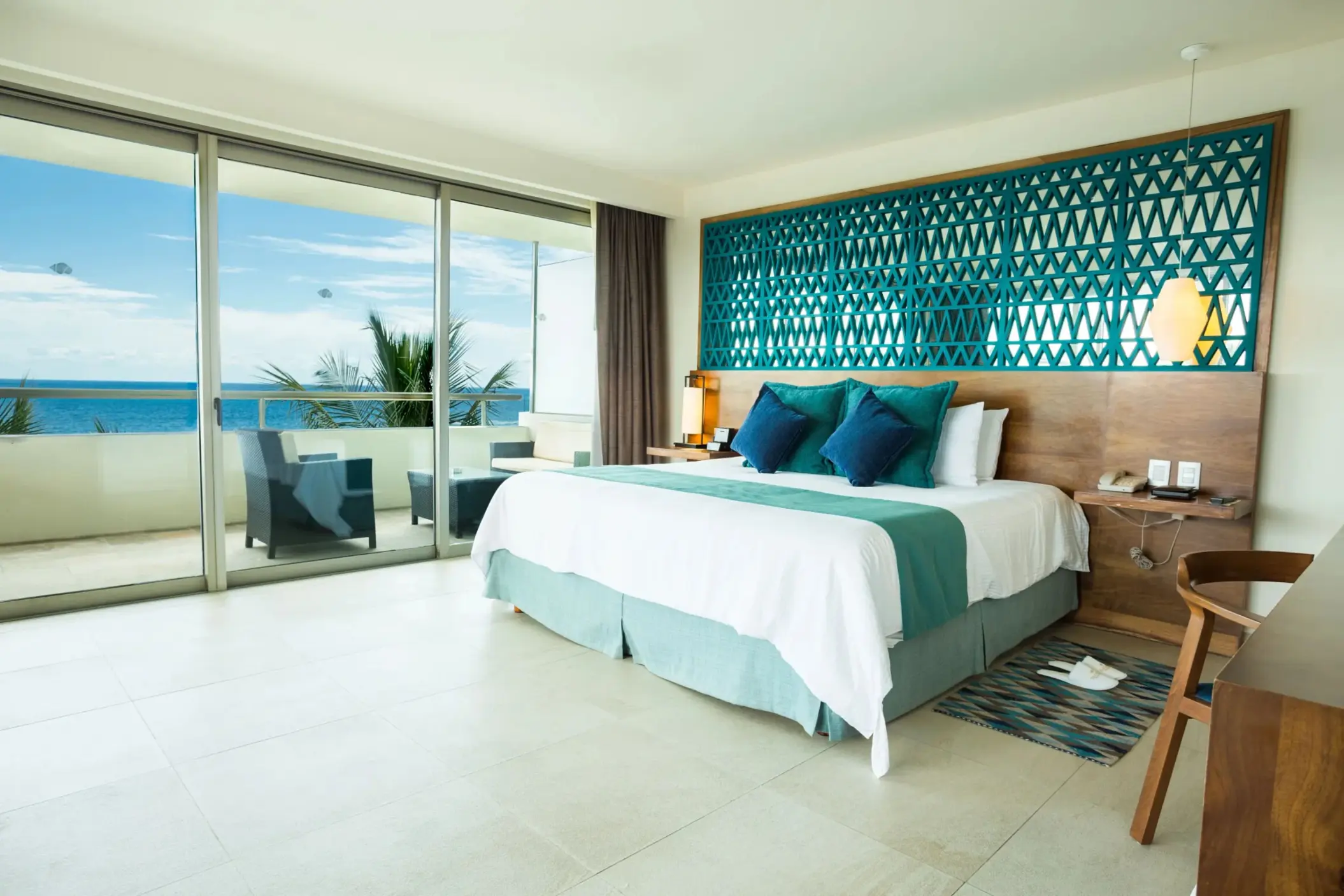Rooftop suite terrace with plunge pool, sun loungers, ocean view, and cozy lounge seating.