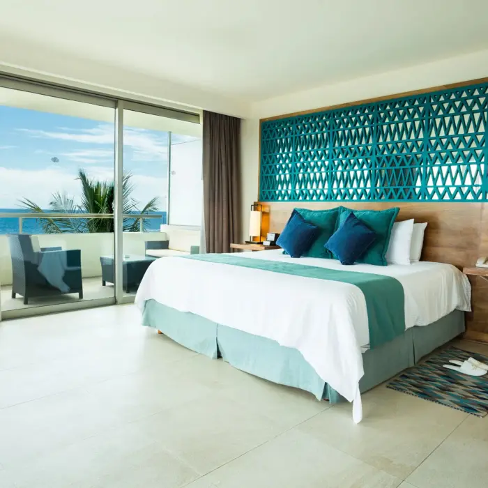 Rooftop suite terrace with plunge pool, sun loungers, ocean view, and cozy lounge seating.