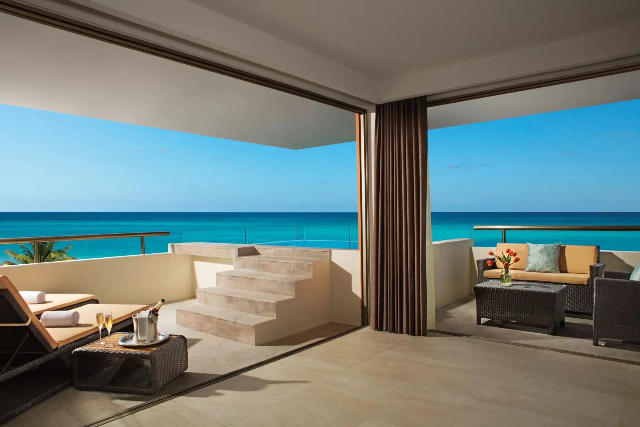 Oceanfront rooftop terrace with plunge pool, outdoor seating, and steps leading to panoramic views.