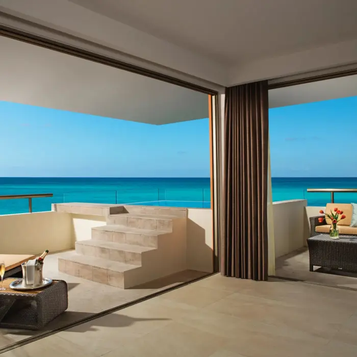 Oceanfront rooftop terrace with plunge pool, outdoor seating, and steps leading to panoramic views.
