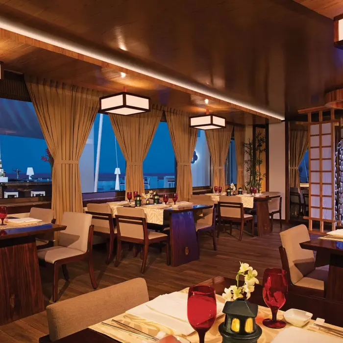 Gohan sushi restaurant with sleek black tables, hanging lights, and artistic Asian-inspired décor.