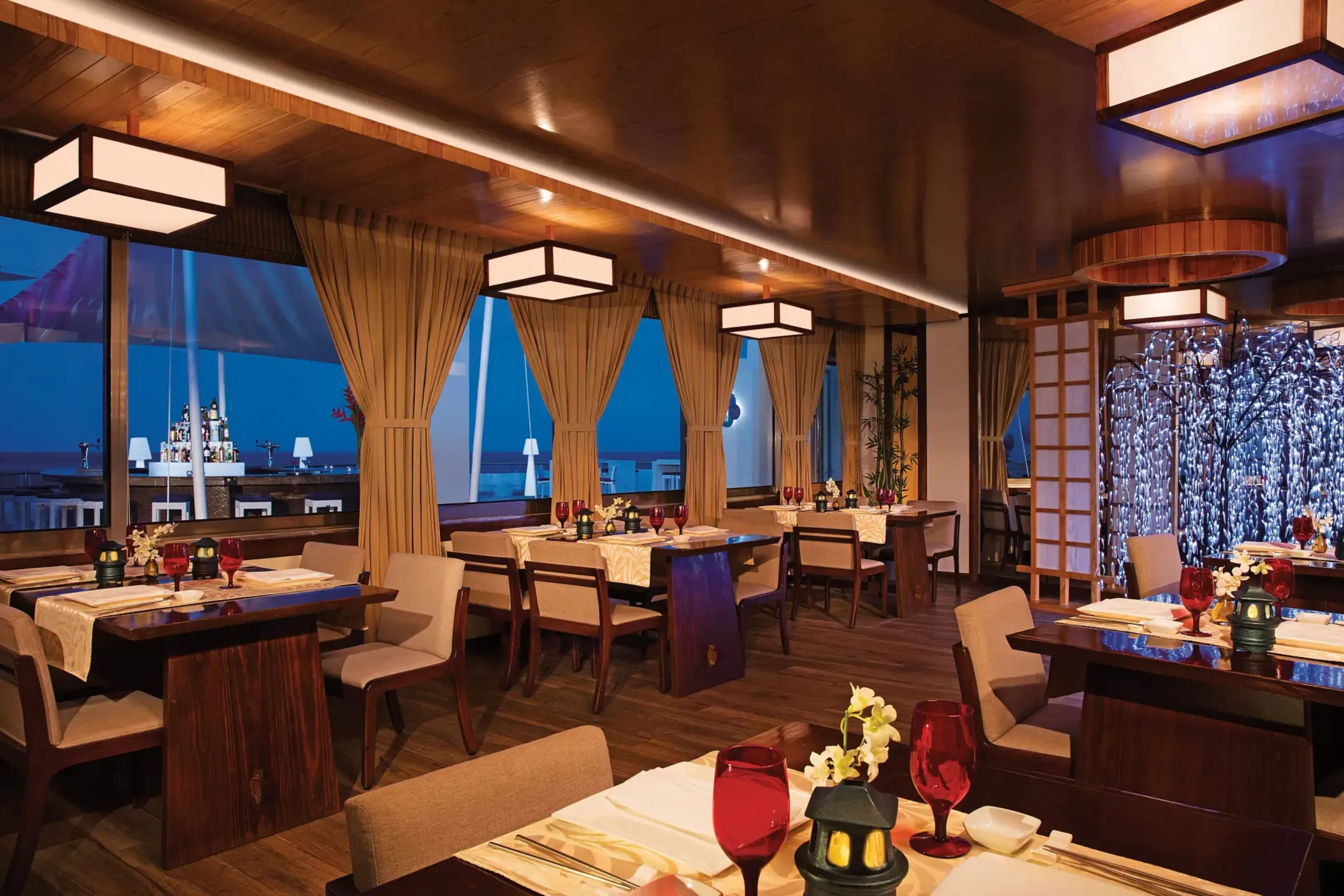 Gohan sushi restaurant with sleek black tables, hanging lights, and artistic Asian-inspired décor.