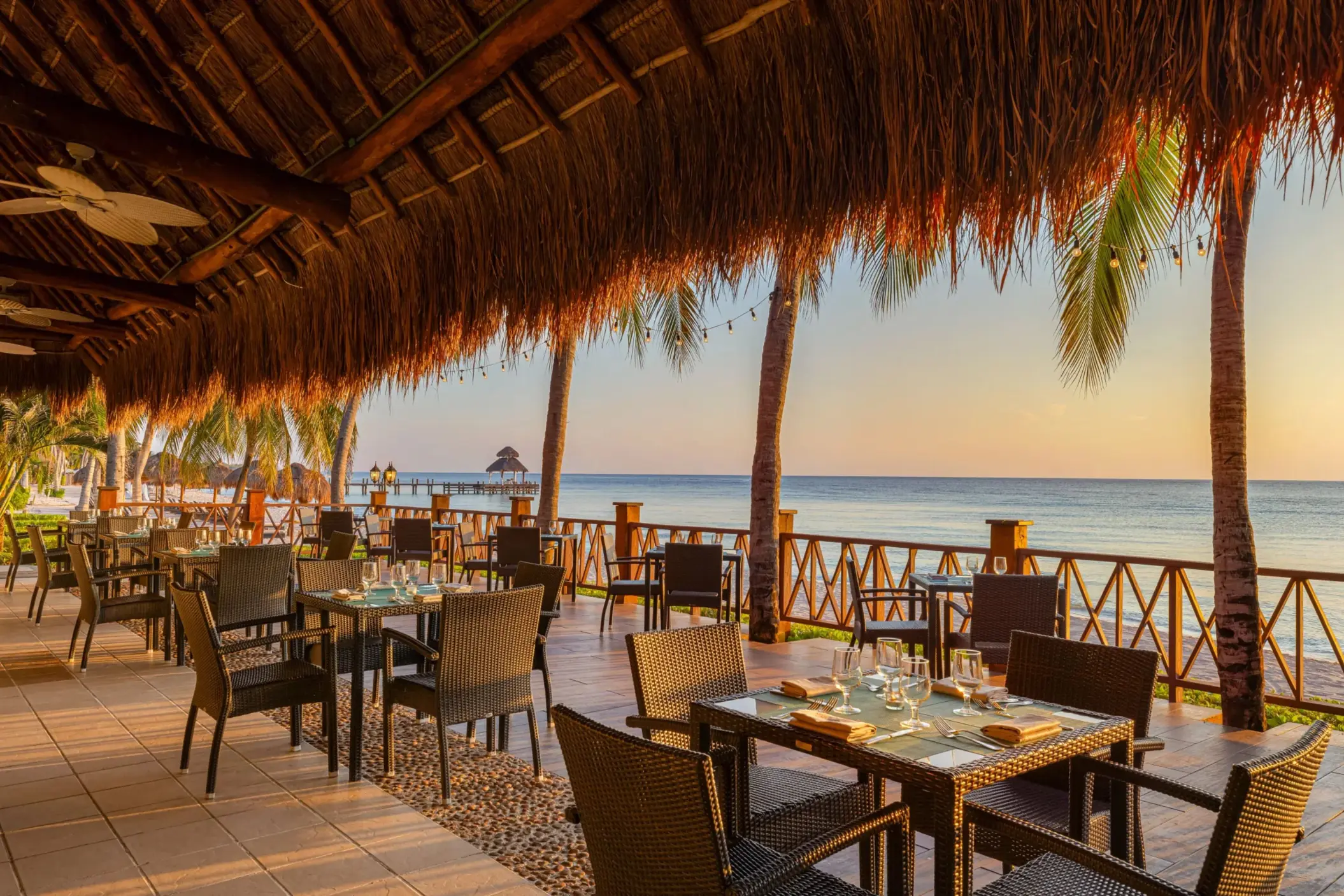 Spacious buffet-style Market Café with modern lighting, large seating area, and tropical touches.