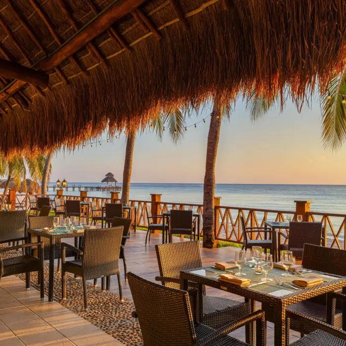 Spacious buffet-style Market Café with modern lighting, large seating area, and tropical touches.