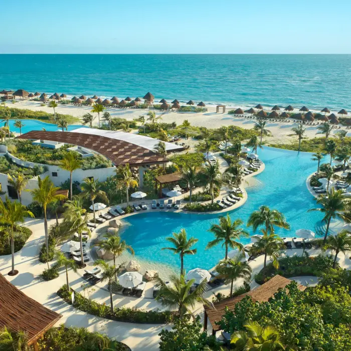 Bird’s-eye view of the Preferred Club pool area with cabanas and views of the Caribbean Sea.