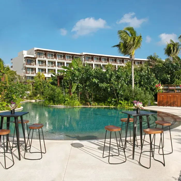 Outdoor cocktail setup next to a serene jungle pool, perfect for private events or receptions.