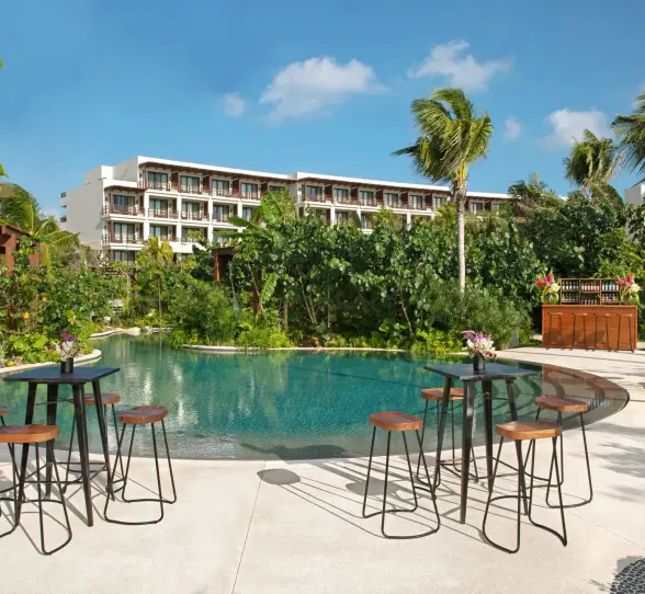 Outdoor cocktail setup next to a serene jungle pool, perfect for private events or receptions.