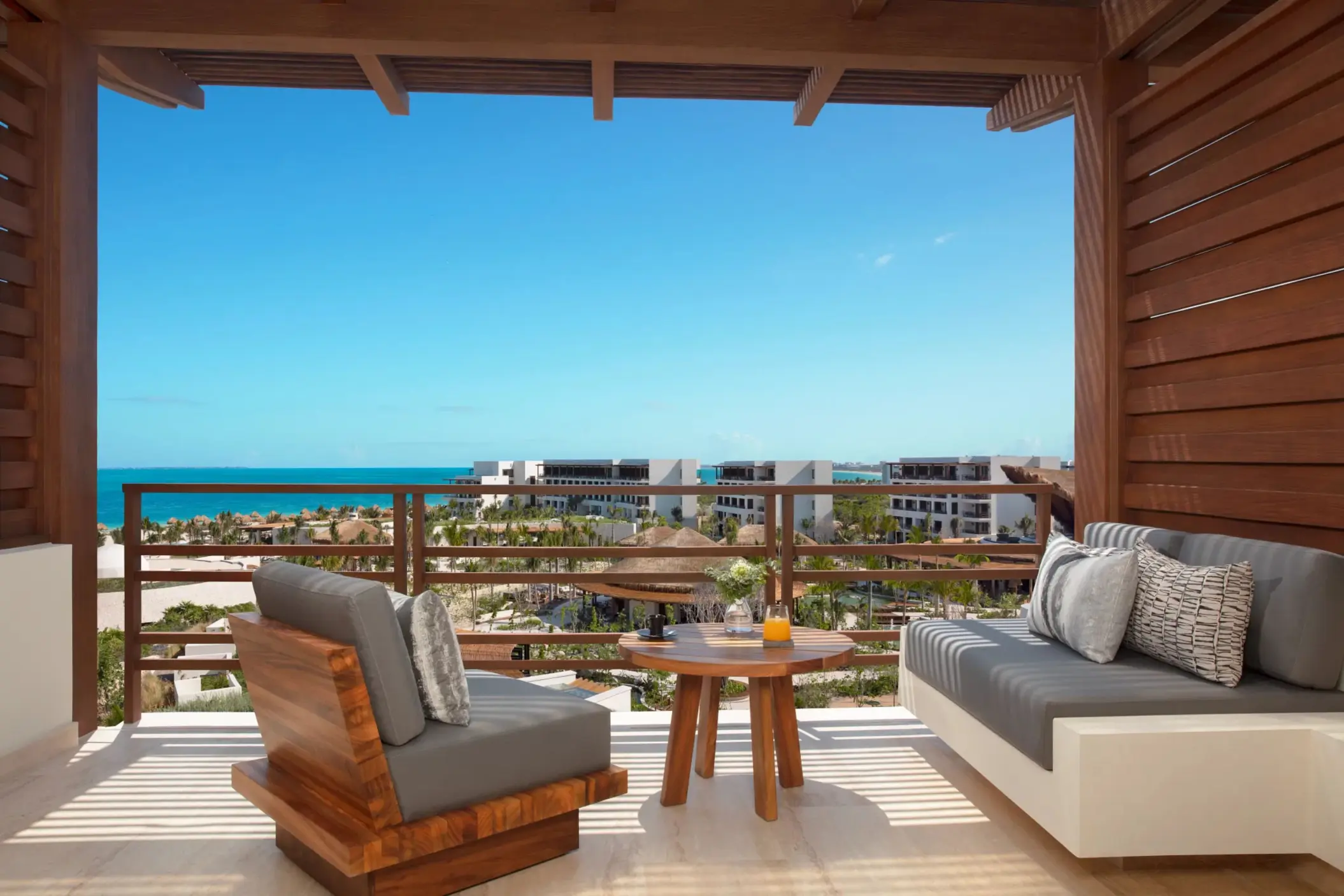 Private oceanview terrace with wooden lounge chairs and stunning sea views.