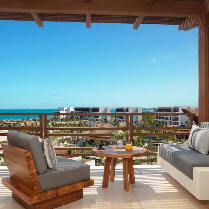 Private oceanview terrace with wooden lounge chairs and stunning sea views.