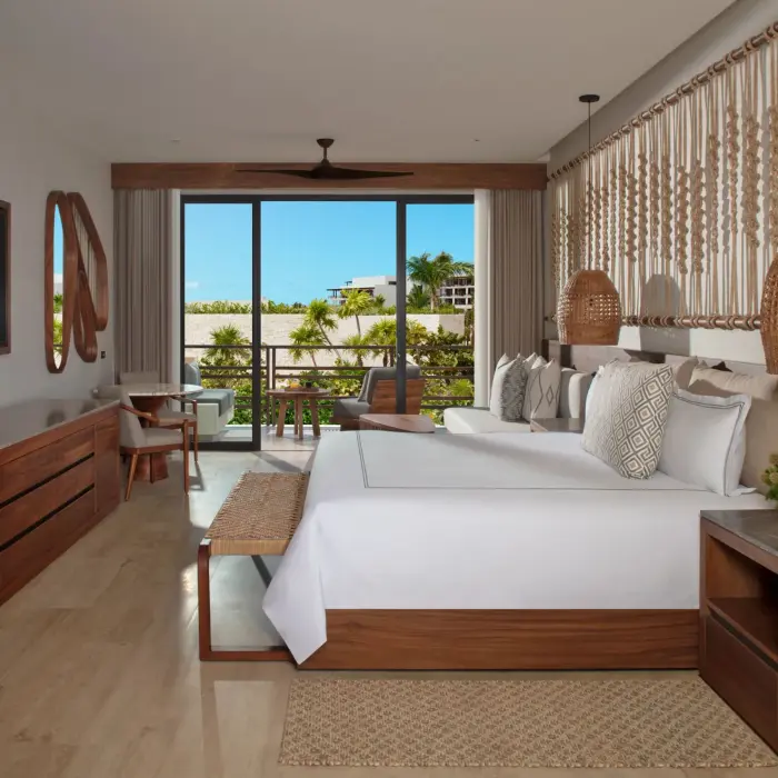 Cozy junior suite interior with natural wood accents, flat screen TV, and balcony.