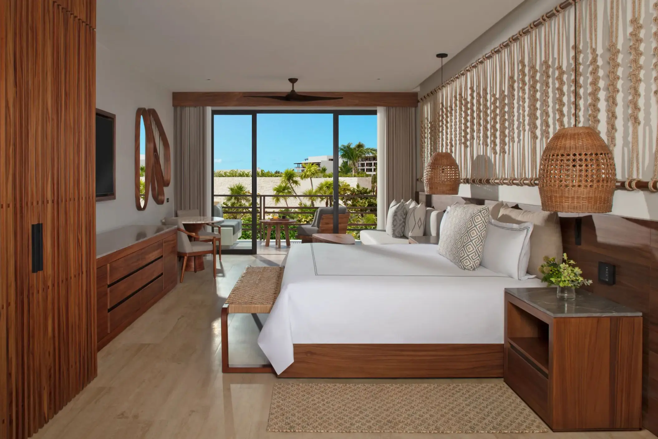 Cozy junior suite interior with natural wood accents, flat screen TV, and balcony.