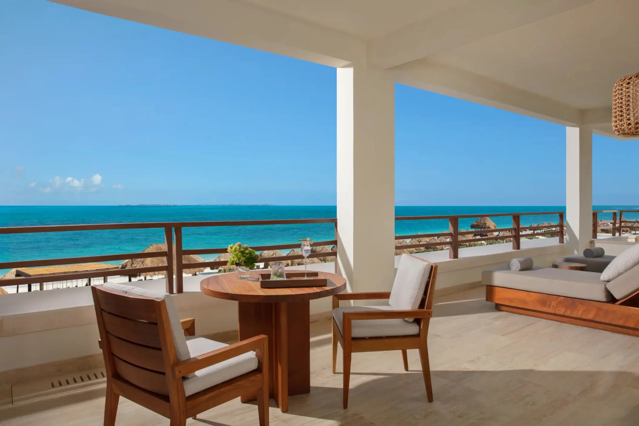 Expansive terrace with lounge seating and direct ocean views from the corner master suite.
