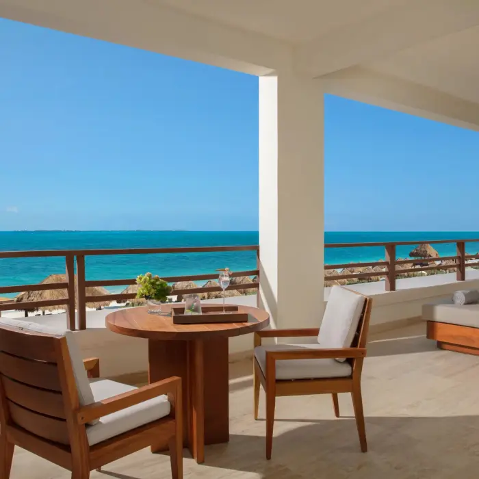 Expansive terrace with lounge seating and direct ocean views from the corner master suite.