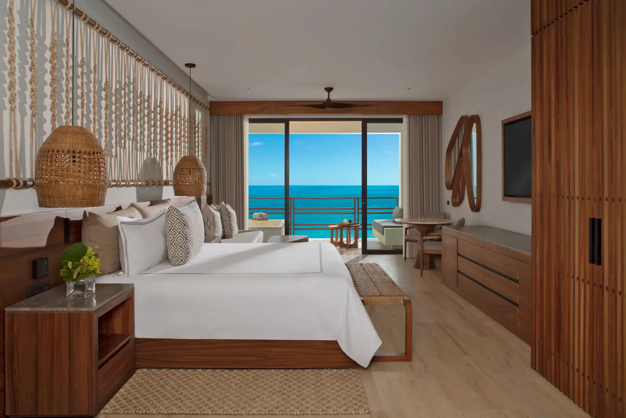 Junior suite with direct oceanfront views, stylish decor, and comfortable seating.