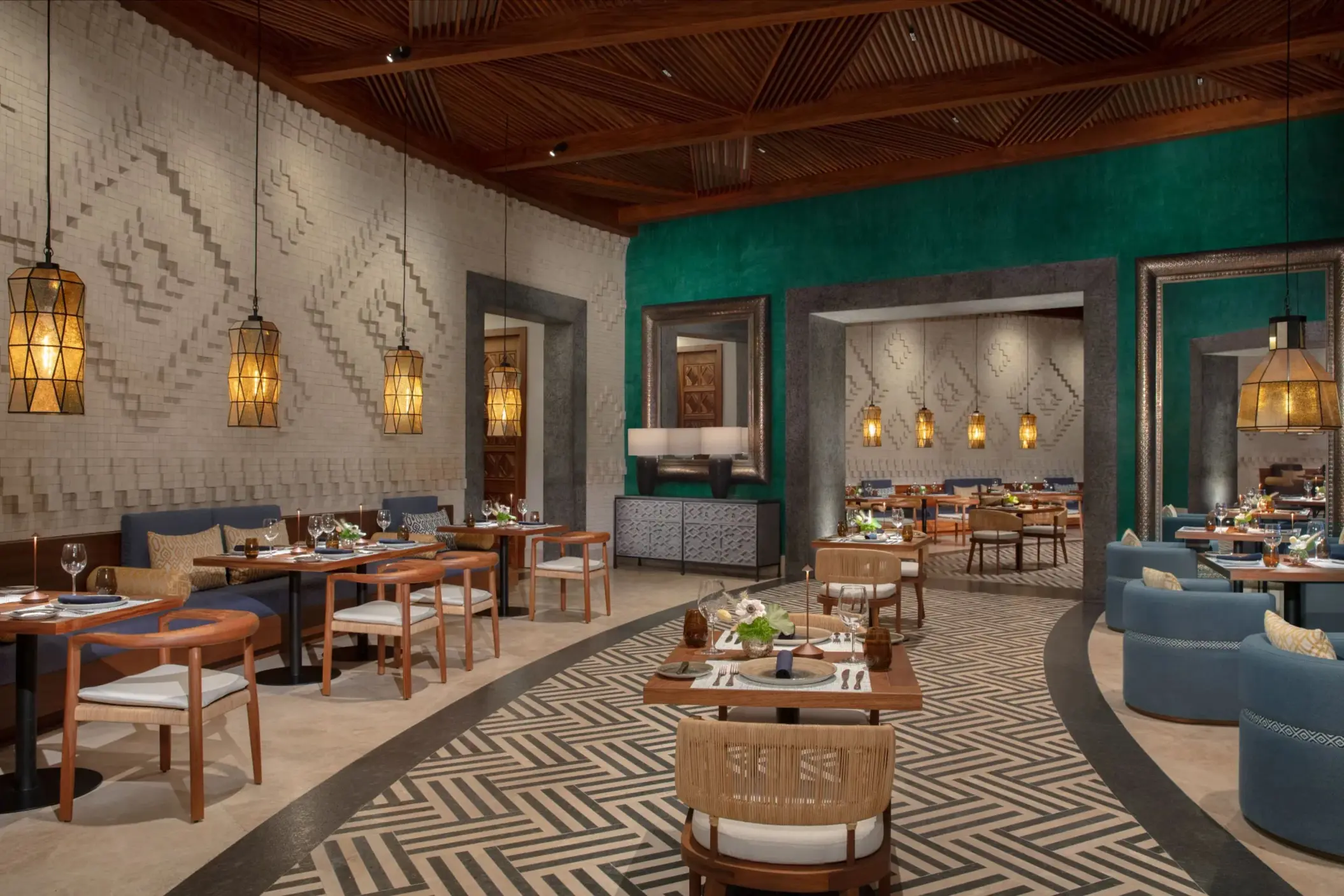 Elegant Mexican restaurant El Patio with geometric accent walls, pendant lights, and warm modern decor.