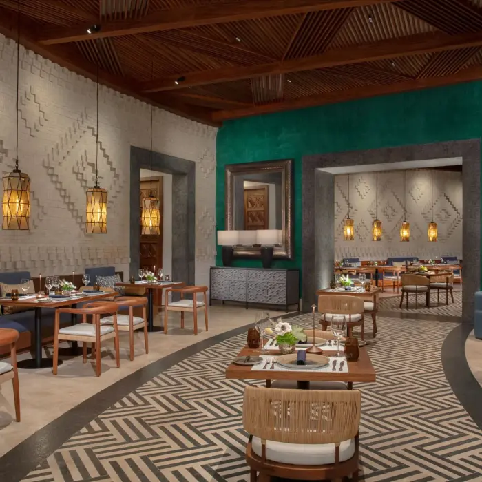 Elegant Mexican restaurant El Patio with geometric accent walls, pendant lights, and warm modern decor.