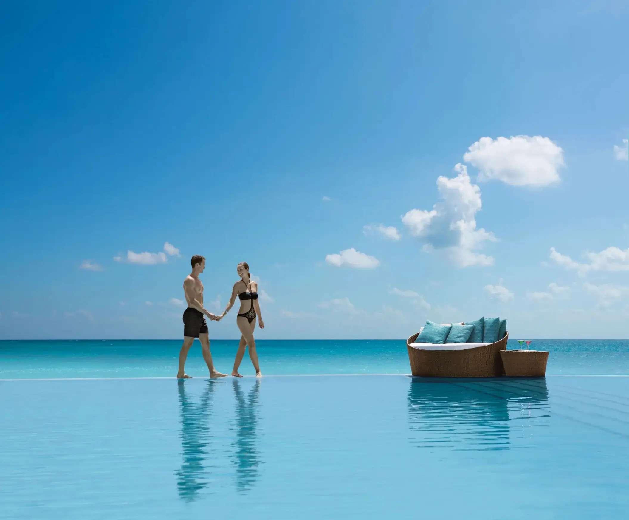 couple at the infinity pool at Secrets The Vine Cancun