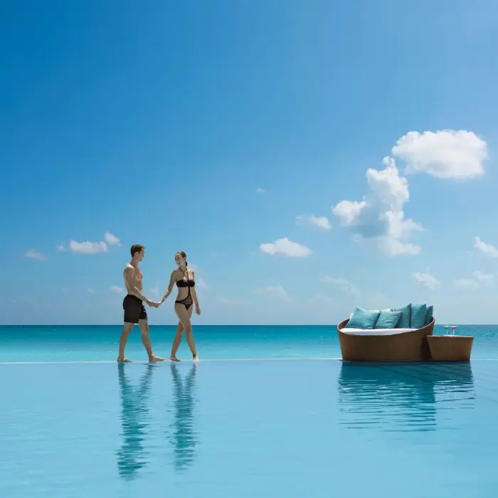 couple at the infinity pool at Secrets The Vine Cancun