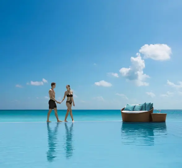 couple at the infinity pool at Secrets The Vine Cancun