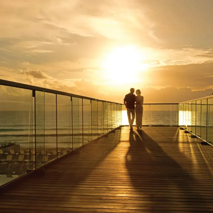 couple on the deck during sunset at Secrets The Vine Cancun