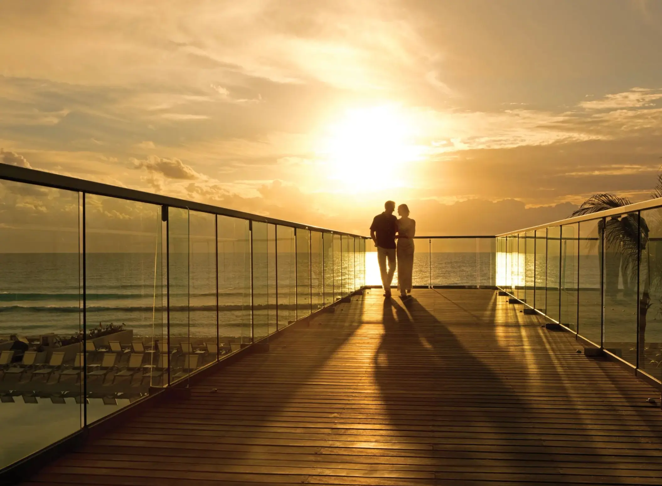 couple on the deck during sunset at Secrets The Vine Cancun