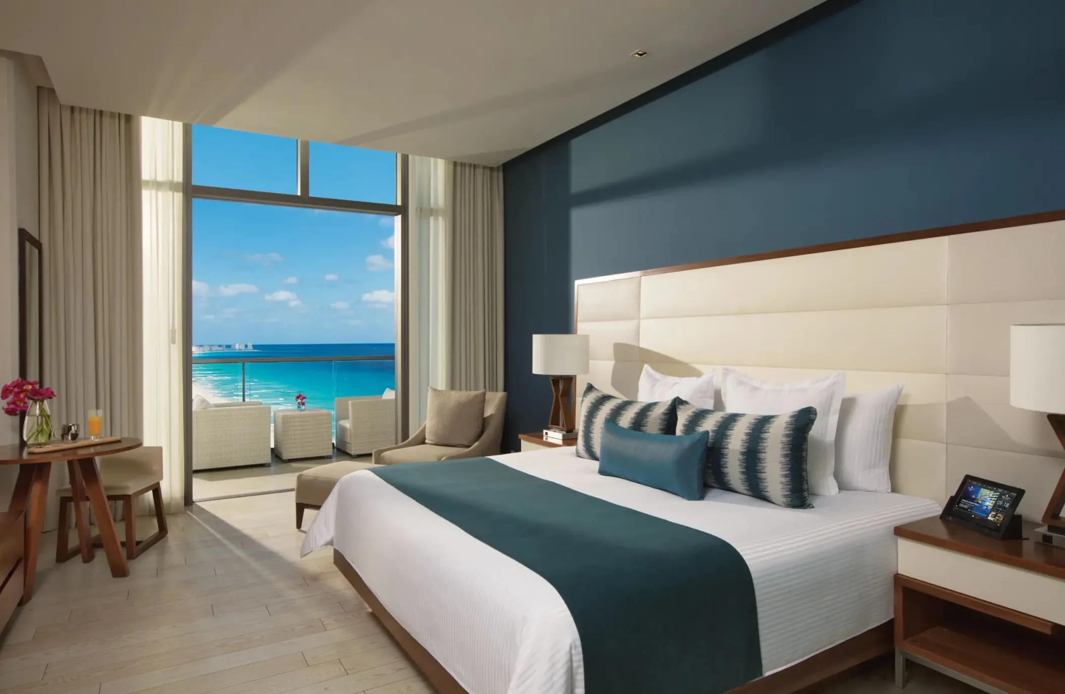deluxe ocean view suite with king bed at Secrets The Vine Cancun