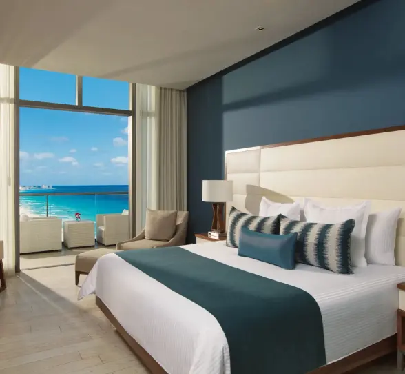 deluxe ocean view suite with king bed at Secrets The Vine Cancun