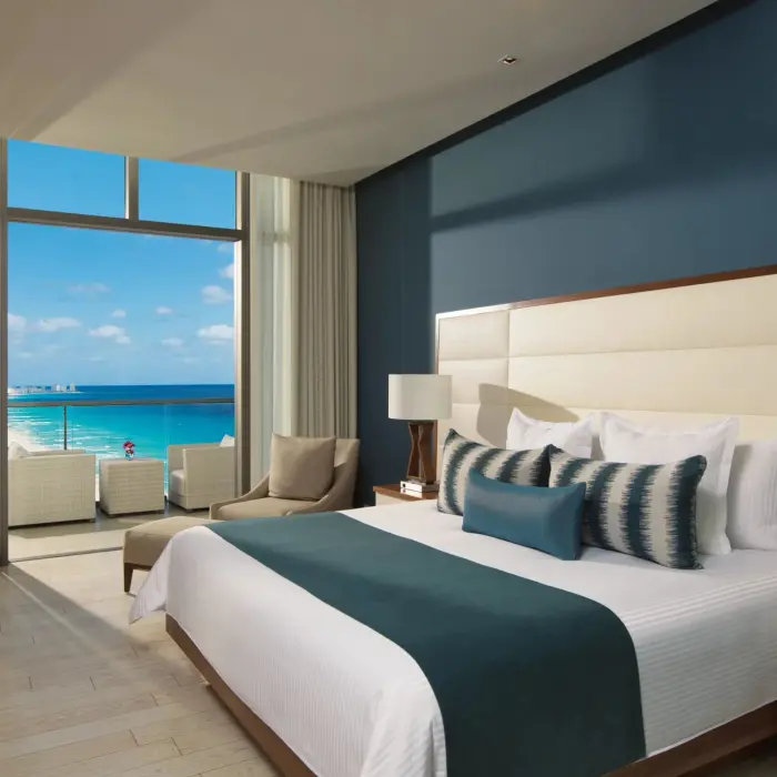 deluxe ocean view suite with king bed at Secrets The Vine Cancun