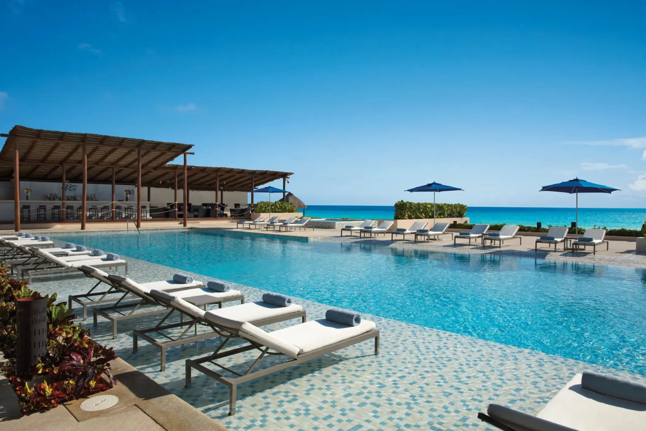 pool with loungers at Secrets The Vine Cancun