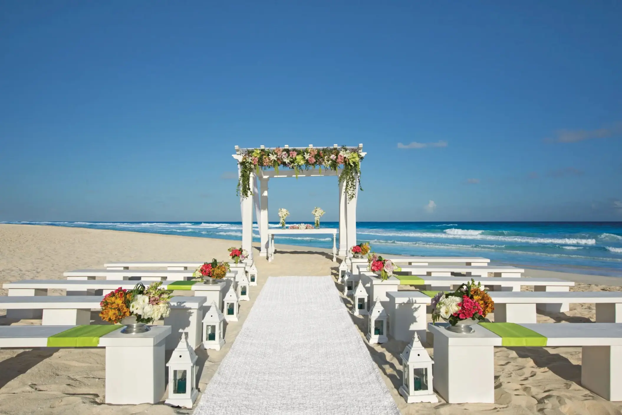 wedding ceremony setup on the beach at Secrets The Vine Cancun