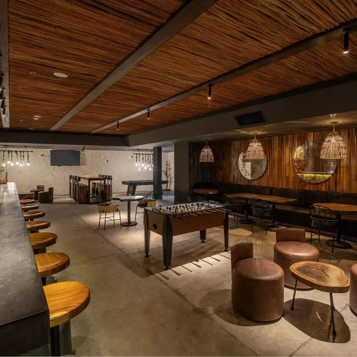 Modern sports bar with sleek stools, large TVs, and a vibrant atmosphere perfect for casual drinks.