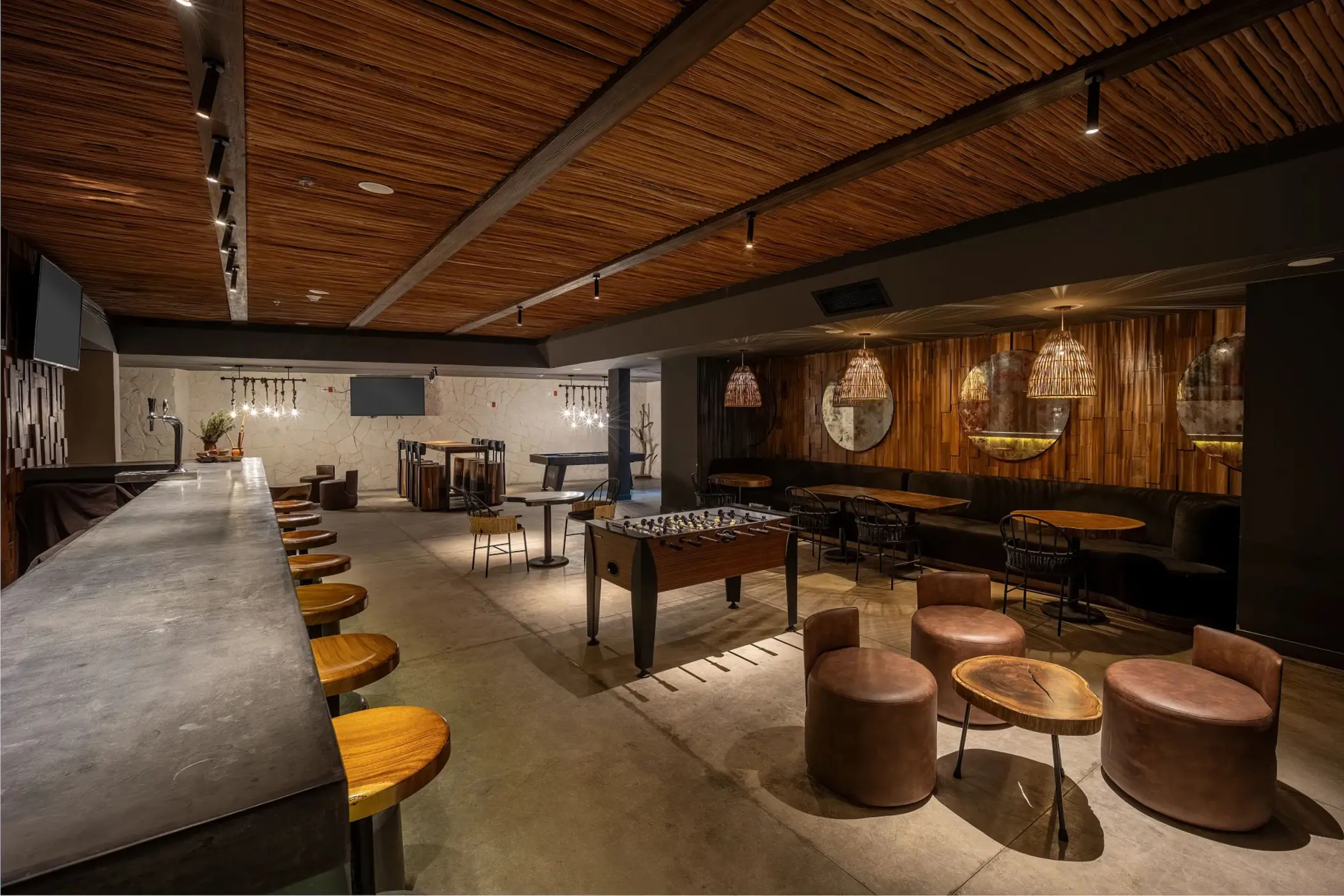 Modern sports bar with sleek stools, large TVs, and a vibrant atmosphere perfect for casual drinks.